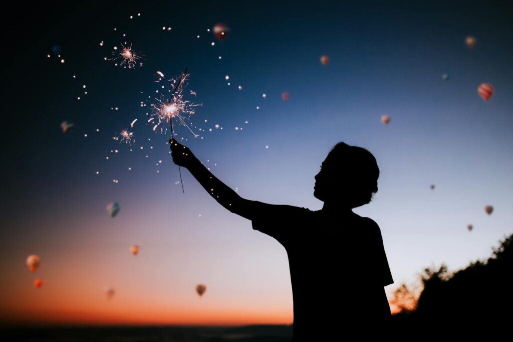 Your Spark Still Matters person holding sparkler silhouette
