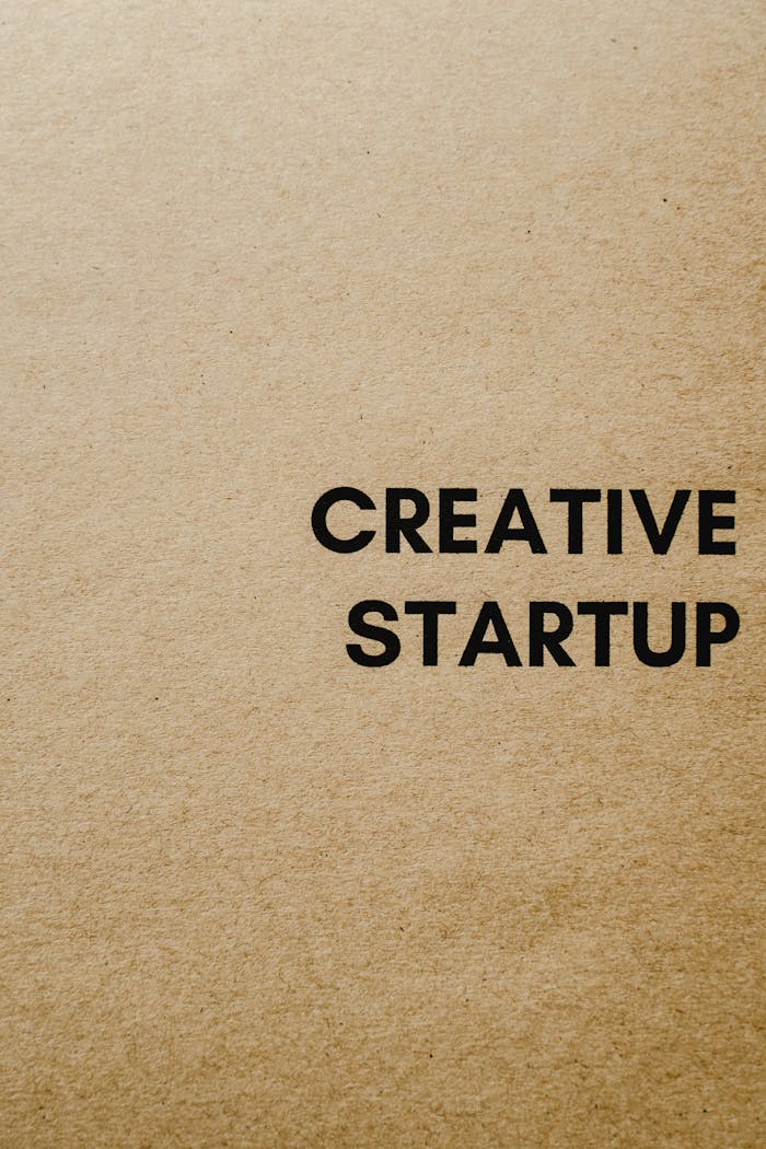 Minimalist brown paper background with 'Creative Startup' text, suitable for business themes.